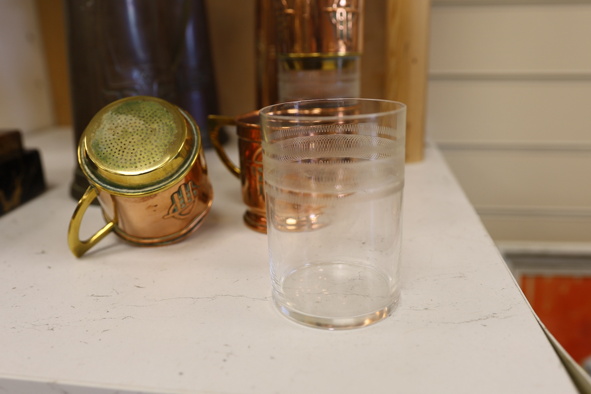 Three Art Nouveau mixed copper and brass coffee pots and two individual copper filter coffee glasses, tallest 36cm high (5). Condition - two pots need cleaning, but good condition for age